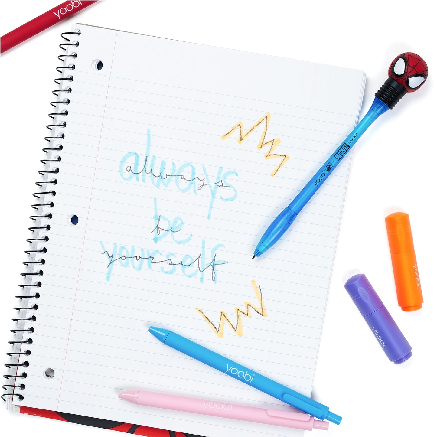 Inside of open one subject spiral notebook showing 3-hole punched perforated college ruled paper.  Shown with pens and highlighters